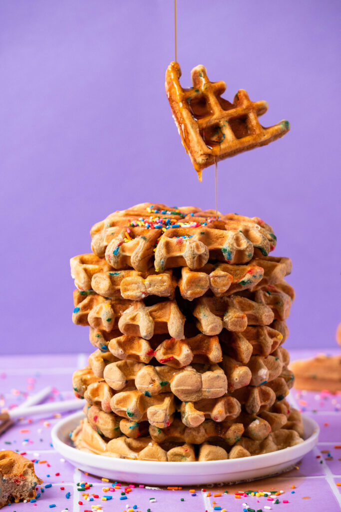 protein waffle chunk falling onto top of waffle stack