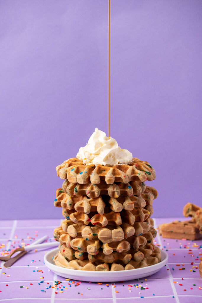 protein waffles with maple syrup streaming on the top
