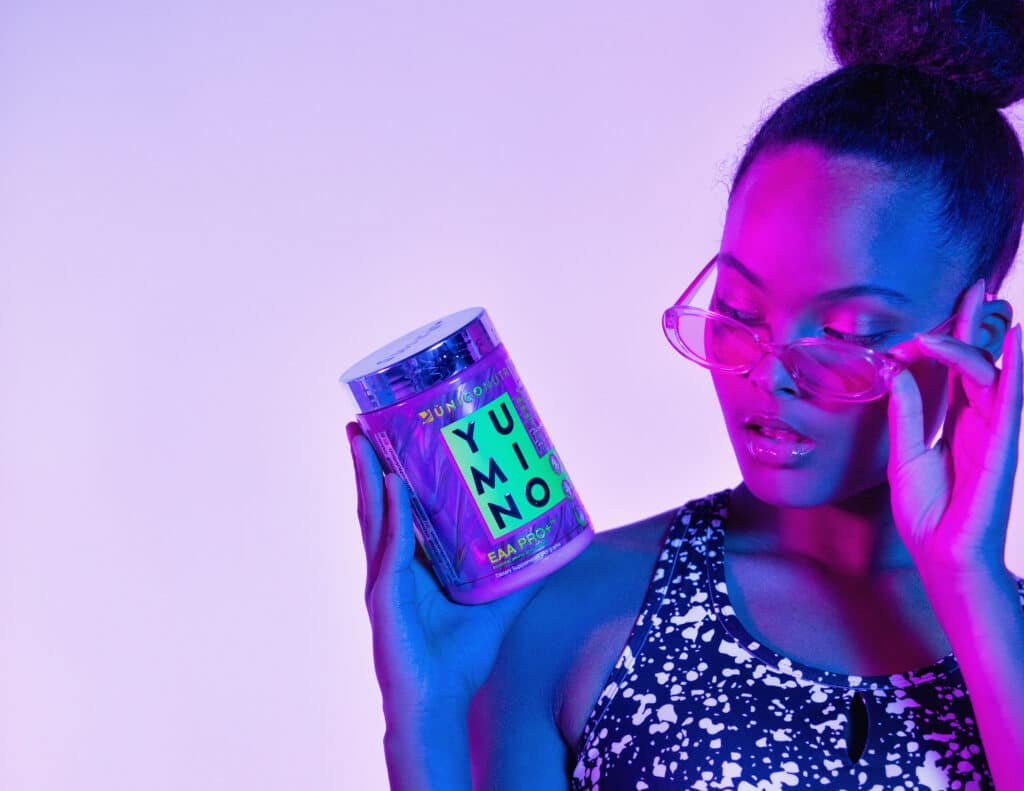 african-american woman studying unico yumino amino acids with trendy glasses on