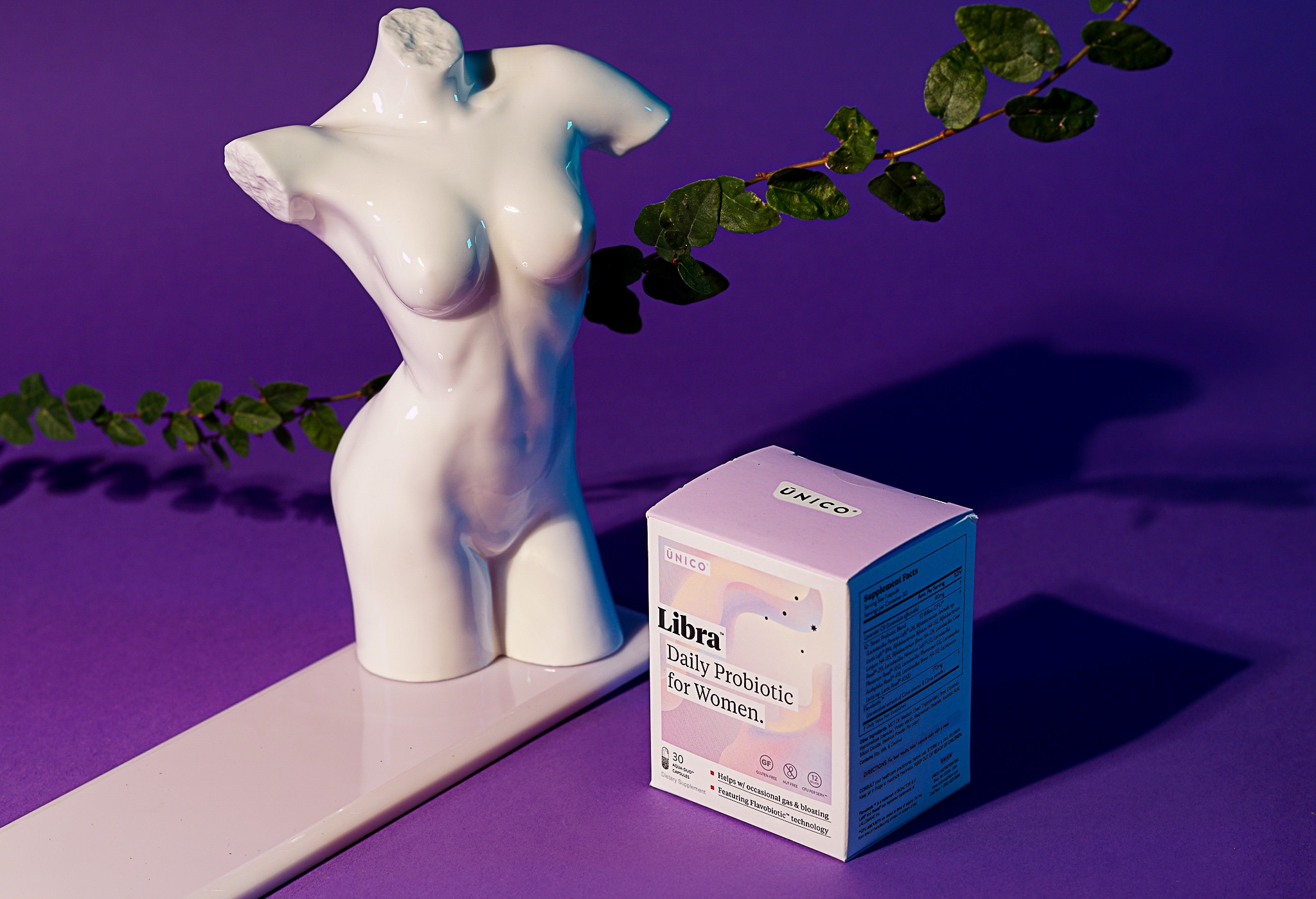 probiotic supplement with female statue and purple background