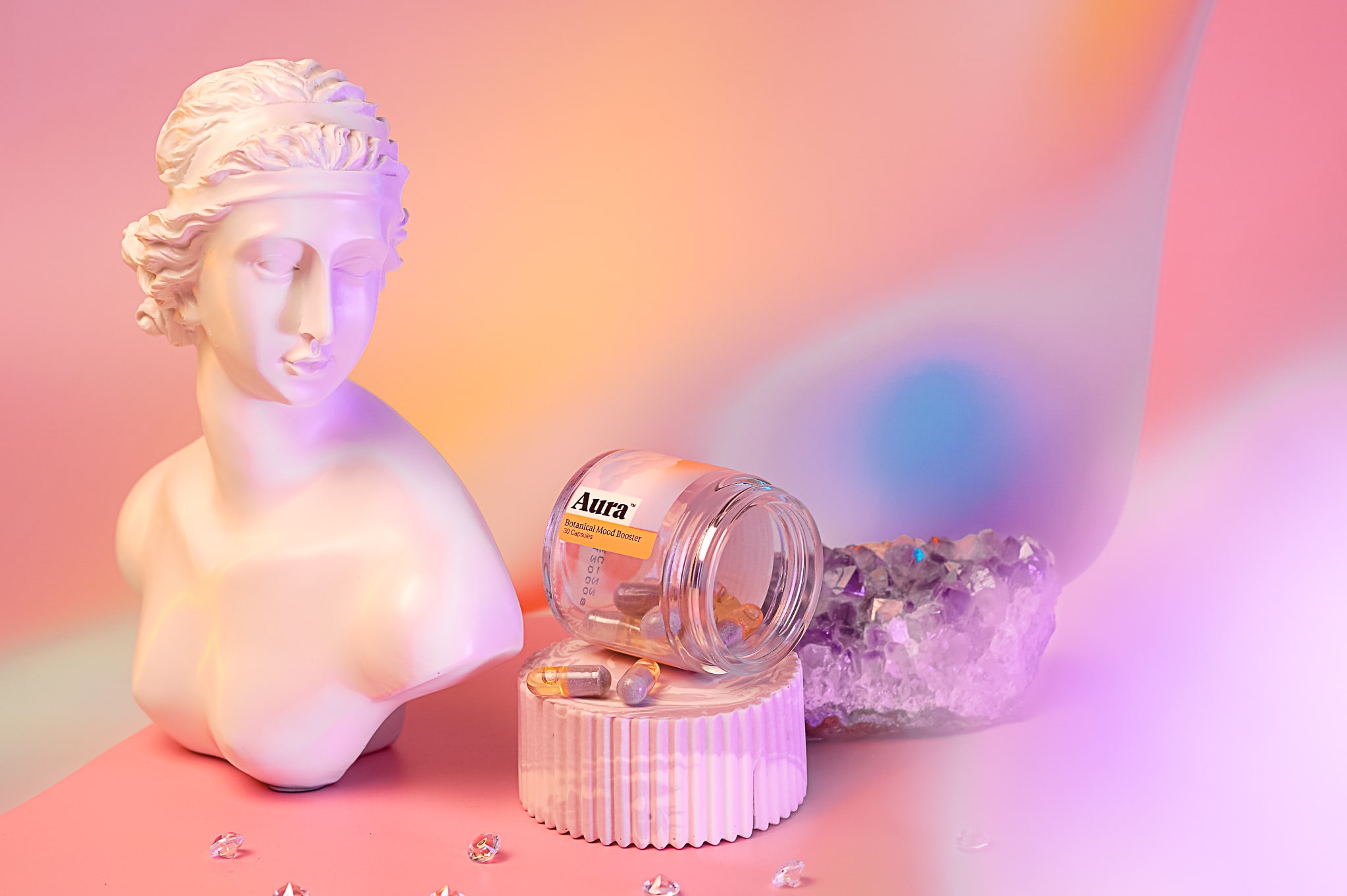 female statue bust with unico product on pedestal with rainbow background